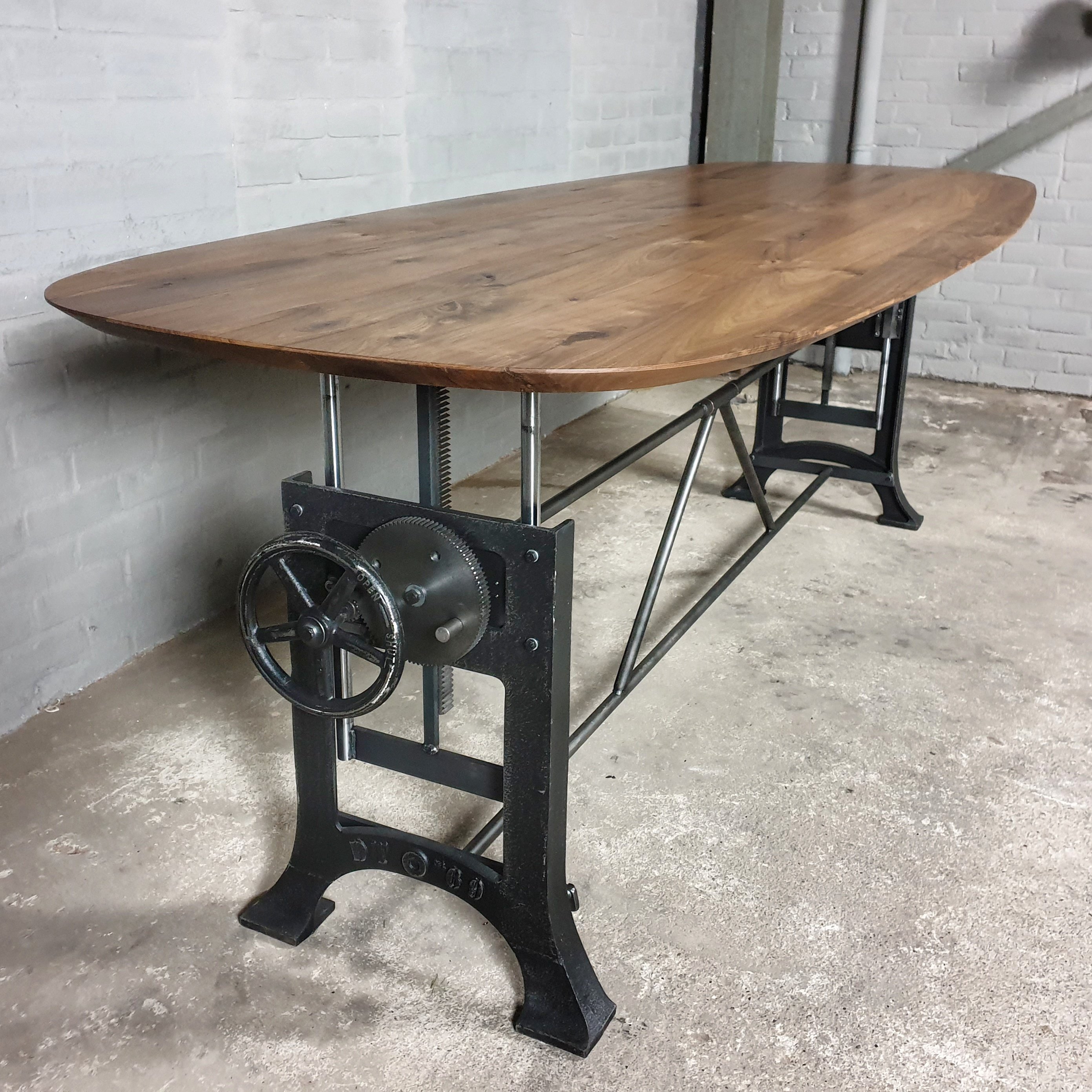 Adjustable in height crank table with an oval American black walnut top